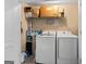 Functional laundry room featuring side-by-side appliances and ample storage space at 1022 Miss Amber Way, Locust Grove, GA 30248