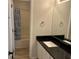 Bathroom with updated vanity, sink, faucet, black granite countertop and tiled shower at 20 Fairway Ln, Peachtree City, GA 30269