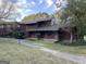 Two-story home featuring a front porch and natural surroundings under a cloudy sky at 20 Fairway Ln, Peachtree City, GA 30269