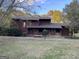 Two-story home features a wood exterior, covered porch, and mature trees at 20 Fairway Ln, Peachtree City, GA 30269