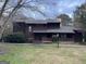 Home featuring traditional design and natural surroundings, set on a cloudy day at 20 Fairway Ln, Peachtree City, GA 30269