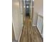 Hallway with wood floors and white walls leading to a naturally lit room at the end at 20 Fairway Ln, Peachtree City, GA 30269