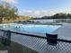 Community pool surrounded by a fence and overlooking the lake, perfect for relaxation at 20 Fairway Ln, Peachtree City, GA 30269