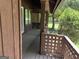 Exterior view of a covered porch with latticework and a glimpse of the wooded surroundings at 20 Fairway Ln, Peachtree City, GA 30269