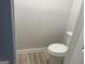 Powder room features a standard white toilet and wood-look floors at 20 Fairway Ln, Peachtree City, GA 30269