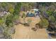 Expansive aerial view showcases the estate with mature trees, lush lawns, circular drive, and detached garage at 426 Old Senoia Rd, Fayetteville, GA 30215