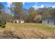 Expansive backyard featuring a shed and a barn surrounded by mature trees at 426 Old Senoia Rd, Fayetteville, GA 30215