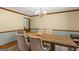 A formal dining room features a modern table setting with neutral tones and ample seating for Gathering gatherings at 426 Old Senoia Rd, Fayetteville, GA 30215