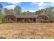 Charming brick home with symmetrical design, manicured bushes, and a well-kept lawn at 426 Old Senoia Rd, Fayetteville, GA 30215