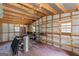 Spacious garage with metal walls, wooden ceiling beams, and ample shelving for storage and organization at 426 Old Senoia Rd, Fayetteville, GA 30215