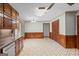 A spacious kitchen boasts wood cabinets and modern appliances, leading into an open, airy eating area at 426 Old Senoia Rd, Fayetteville, GA 30215