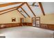 A vast living room displays exposed ceiling beams and wood-paneled walls, capturing natural light and outdoor views at 426 Old Senoia Rd, Fayetteville, GA 30215