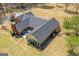 Aerial view of the beautiful rear exterior with patio, lush green lawn, sunroom, and well-manicured landscaping at 426 Old Senoia Rd, Fayetteville, GA 30215