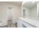 Bathroom featuring granite countertops, a large mirror, and wood grain flooring at 301 Limestone Circle, Conyers, GA 30013