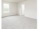 An empty bedroom with neutral carpet, a window, and a white door at 301 Limestone Circle, Conyers, GA 30013