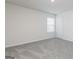 Cozy bedroom with soft grey carpet, natural light from the window, and a white door at 301 Limestone Circle, Conyers, GA 30013