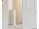 A carpeted hallway with white baseboards, neutral walls, and a white door at 301 Limestone Circle, Conyers, GA 30013