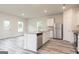 Bright kitchen features an island with a sink, granite counters, stainless steel appliances, and wood grain flooring at 301 Limestone Circle, Conyers, GA 30013