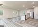 Bright, open floor plan with wood-look flooring, stainless steel appliances, and a kitchen island at 301 Limestone Circle, Conyers, GA 30013