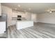 Open-concept living space with wood-look flooring and a modern kitchen at 301 Limestone Circle, Conyers, GA 30013