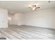 Spacious living room with wood-look floors, a ceiling fan, and bright, neutral walls at 301 Limestone Circle, Conyers, GA 30013