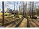 Lush backyard with mature trees, a play area, and a well-maintained lawn surrounding a large house at 801 Streamside Dr, Mcdonough, GA 30252