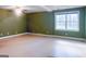 Unfinished basement with concrete floor, green walls, ceiling fan, and a window at 801 Streamside Dr, Mcdonough, GA 30252