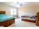 Spacious bedroom with two beds, neutral walls, carpet, and a ceiling fan at 801 Streamside Dr, Mcdonough, GA 30252