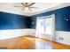 Bright bedroom with hardwood floors, large window, and fresh paint at 801 Streamside Dr, Mcdonough, GA 30252