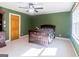 Bedroom featuring neutral carpet, green walls, ceiling fan, and a wooden dresser at 801 Streamside Dr, Mcdonough, GA 30252