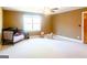 Large bedroom with neutral carpet, a window, and a rocking horse at 801 Streamside Dr, Mcdonough, GA 30252