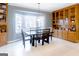 Dining room with large window view, built-in wood cabinets, and seating for six at 801 Streamside Dr, Mcdonough, GA 30252