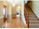 Inviting foyer with hardwood floors, staircase, and elegant lighting at 801 Streamside Dr, Mcdonough, GA 30252