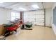 Well-lit garage equipped with garage door, ample space, and convenient workbench for various projects at 801 Streamside Dr, Mcdonough, GA 30252