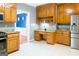 Well-equipped kitchen featuring light wood cabinets, granite countertops, and modern stainless steel refrigerator at 801 Streamside Dr, Mcdonough, GA 30252