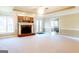 Spacious living room with brick fireplace, plush carpet, and natural light at 801 Streamside Dr, Mcdonough, GA 30252