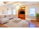 Bright living room with built-in shelving, hardwood floors, and contemporary furniture and light gray color scheme at 801 Streamside Dr, Mcdonough, GA 30252