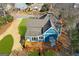 Aerial view of a beautiful blue house with a large wooden deck and a well-maintained yard at 85 Bryan St, Mcdonough, GA 30253