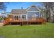 Charming blue house with a spacious wooden deck, perfect for outdoor entertaining and relaxation at 85 Bryan St, Mcdonough, GA 30253