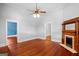 Bright living room featuring hardwood floors, a ceiling fan, and a decorative fireplace at 85 Bryan St, Mcdonough, GA 30253