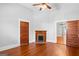 Living room featuring a fireplace and original hardwood floors, with natural light coming in from other rooms at 85 Bryan St, Mcdonough, GA 30253