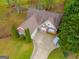Aerial view of a brick home with a landscaped front yard and a long driveway at 324 Sue Ct, Temple, GA 30179