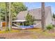 Relaxing backyard oasis with a hammock, mature trees, and a serene view of the home's exterior at 324 Sue Ct, Temple, GA 30179
