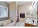 Bathroom featuring a corner soaking tub, a window, and a vanity sink at 324 Sue Ct, Temple, GA 30179
