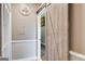 Hallway with a light colored sliding wooden barn door and bourbon distillery wall decoration at 324 Sue Ct, Temple, GA 30179