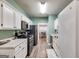 A view of the kitchen with stainless appliances and a view into the dining room at 324 Sue Ct, Temple, GA 30179