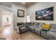 Open concept living room with hardwood floors, comfortable sofa, and contemporary artwork at 324 Sue Ct, Temple, GA 30179