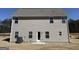 Rear view of a home featuring neutral siding and complementary roof, with a door leading to the backyard at 465 Cantrell Drive, Dallas, GA 30157