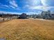 View of a large grassy backyard surrounded by a rustic wooden fence and neighborhood homes at 3695 Andover St, Cumming, GA 30028