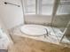 Primary bathroom featuring luxurious soaking tub, marble surround, and elegant fixtures at 3695 Andover St, Cumming, GA 30028